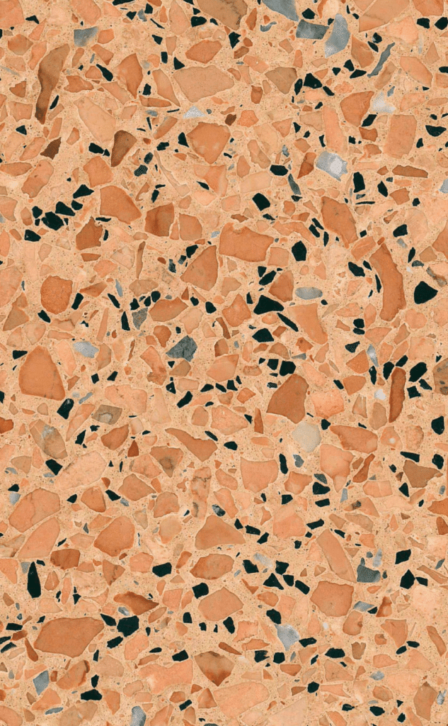 Zdjęcie płytki lastryko RONUV terrazzo o ciepłej, pomarańczowej tonacji z widocznymi drobinkami kruszywa w odcieniach czerni, szarości i beżu, idealnej do wnętrz mieszkalnych i komercyjnych.